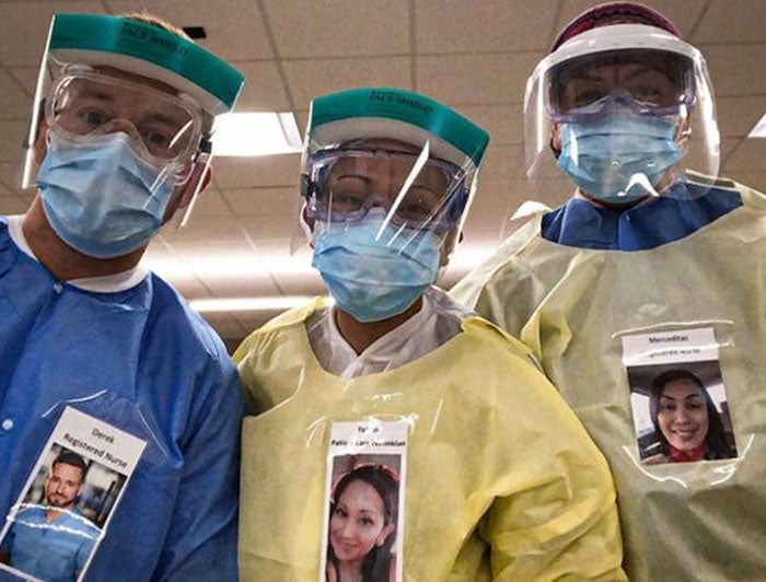 Health Care Workers in PPE Wear Photos of Themselves Smiling to Comfort
