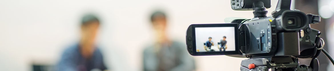 Video camera with viewscreen looking at two people faded out of view