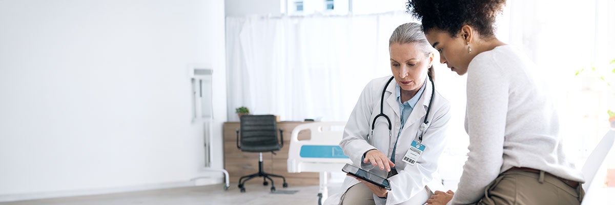Female doctor sits in consult with patient