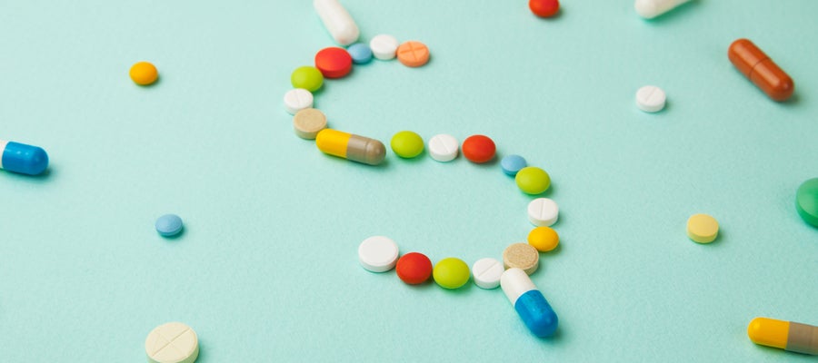 Pills arranged as a dollar sign