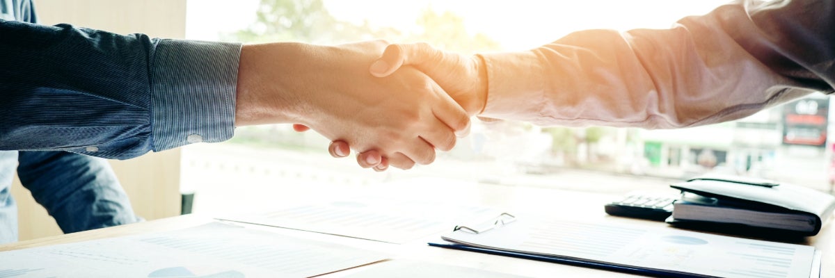 Two people shaking hands. 
