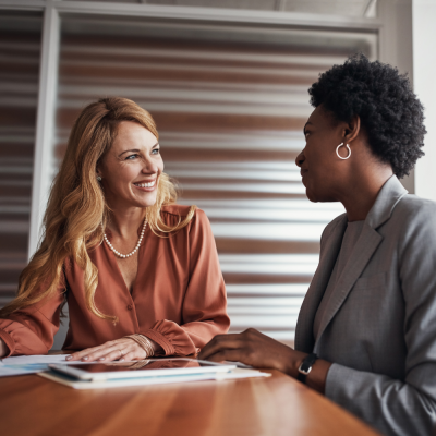 Two business women discussing social media and communication