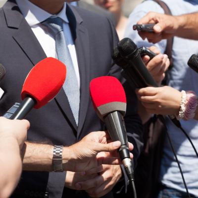 Man getting interviewed by multiple press media